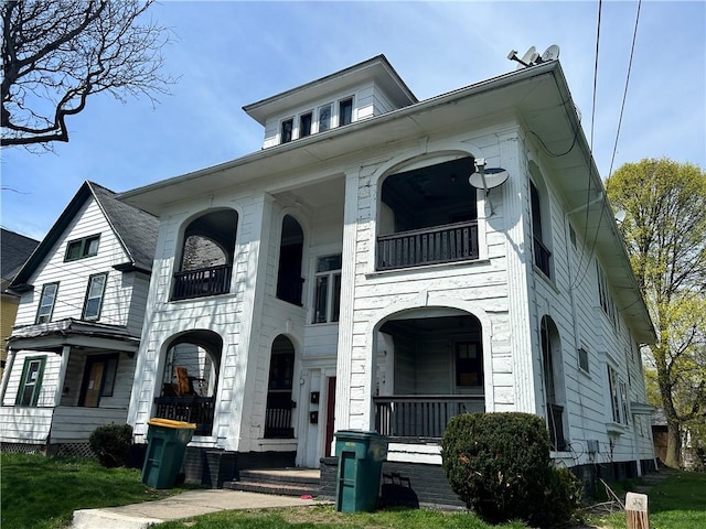 view of front of property with a balcony and covered porch
