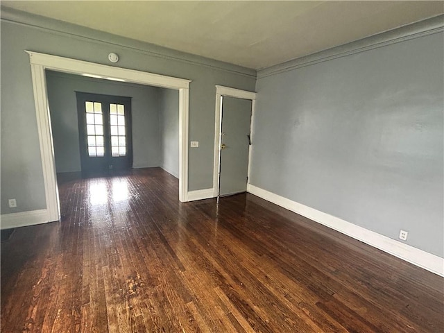 unfurnished room featuring french doors, hardwood / wood-style flooring, baseboards, and a smoke detector