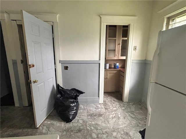 laundry area featuring light marble finish flooring
