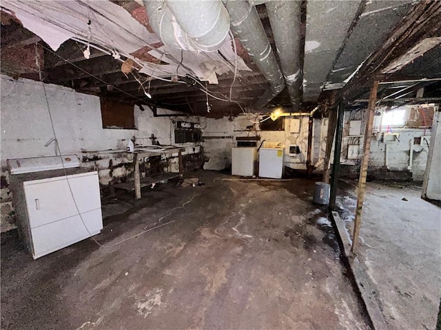 below grade area with washer and clothes dryer