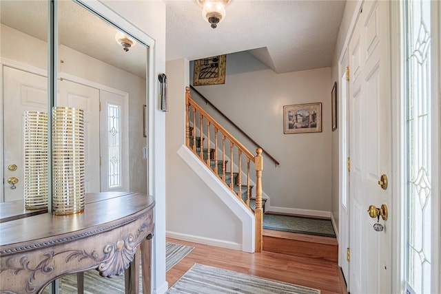 1430 Erie Station Rd, Henrietta, NY 14467 - foyer featuring wood finished floors, baseboards, stairs, and a textured ceiling