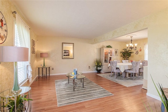 1430 Erie Station Rd, Henrietta, NY 14467 - living area with wood finished floors, a chandelier, and baseboards