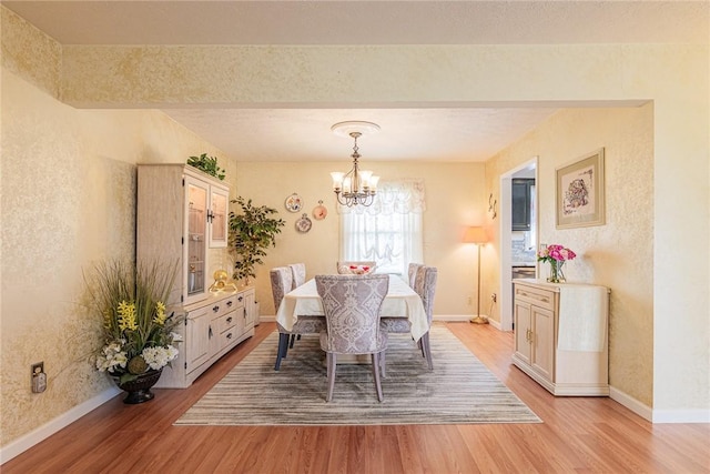 1430 Erie Station Rd, Henrietta, NY 14467 - dining space featuring light wood-type flooring, a chandelier, and baseboards