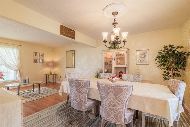 1430 Erie Station Rd, Henrietta, NY 14467 - dining space featuring a chandelier, wood finished floors, and baseboards