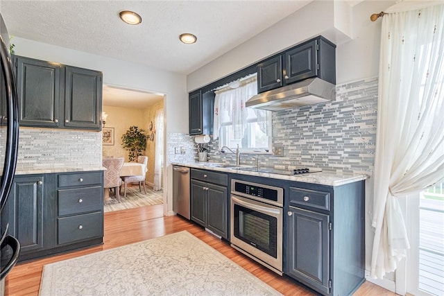 1430 Erie Station Rd, Henrietta, NY 14467 - kitchen with black appliances, under cabinet range hood, light wood-type flooring, backsplash, and a sink