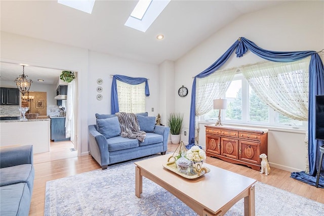 1430 Erie Station Rd, Henrietta, NY 14467 - living room with vaulted ceiling, light wood finished floors, a skylight, a chandelier, and baseboards