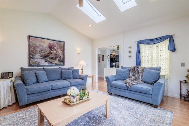 1430 Erie Station Rd, Henrietta, NY 14467 - living room with vaulted ceiling, a skylight, wood finished floors, and recessed lighting