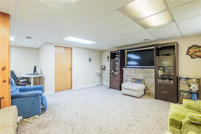 1430 Erie Station Rd, Henrietta, NY 14467 - living area featuring carpet, a paneled ceiling, a stone fireplace, baseboards, and an office area