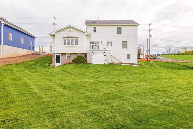 1430 Erie Station Rd, Henrietta, NY 14467 - rear view of house with stairs, a yard, and a deck