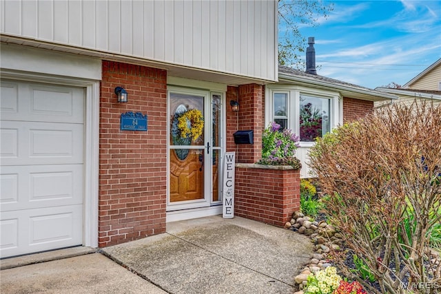 entrance to property featuring brick siding and an attached garage