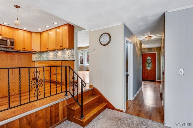 stairway with baseboards, recessed lighting, and wood finished floors