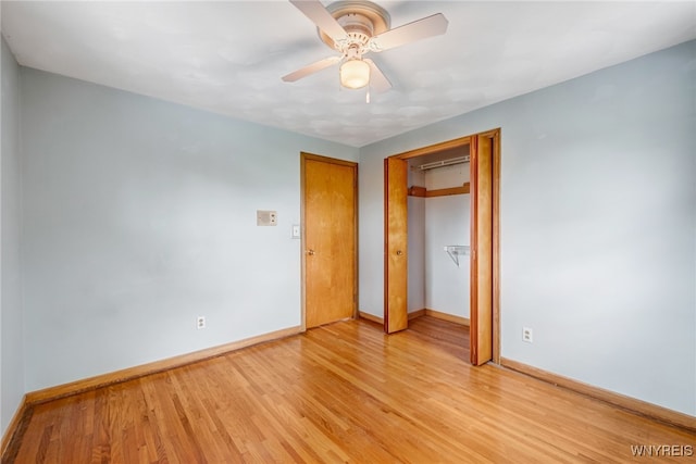 unfurnished bedroom with baseboards, light wood-style floors, a closet, and a ceiling fan