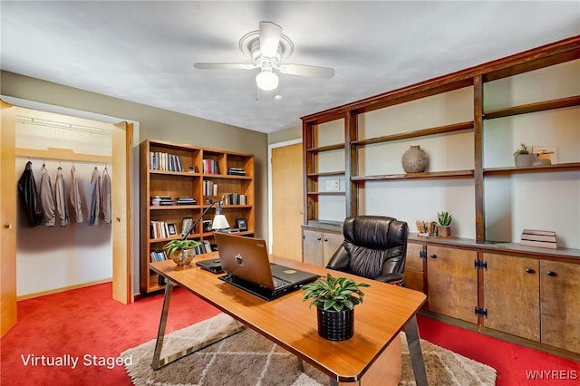 carpeted home office with a ceiling fan and baseboards