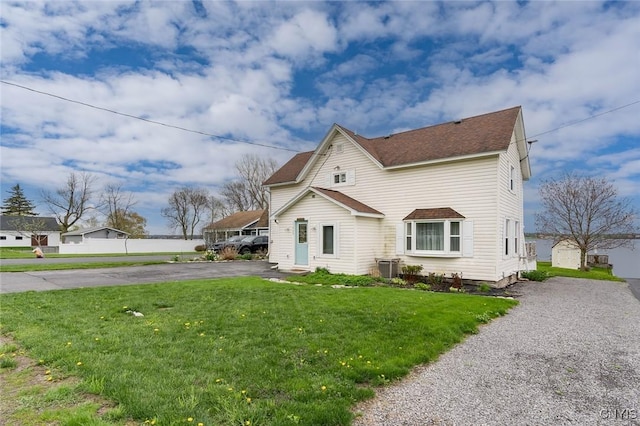 17869 County Route 59, Brownville, NY 13634 - traditional home with asphalt driveway, a front yard, and a shingled roof