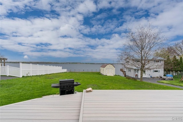 17869 County Route 59, Brownville, NY 13634 - wooden deck with a water view, a storage shed, and an outdoor structure