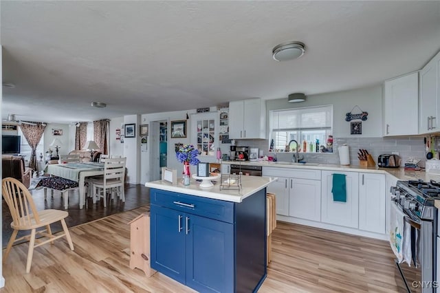 17869 County Route 59, Brownville, NY 13634 - kitchen featuring black range with gas stovetop, a sink, light countertops, and light wood-style flooring