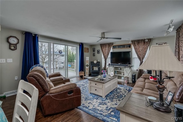 17869 County Route 59, Brownville, NY 13634 - living room featuring a wood stove, a ceiling fan, and wood finished floors