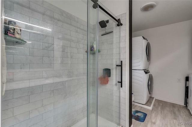 17869 County Route 59, Brownville, NY 13634 - full bath with stacked washer / dryer, a shower stall, wood finished floors, and baseboards