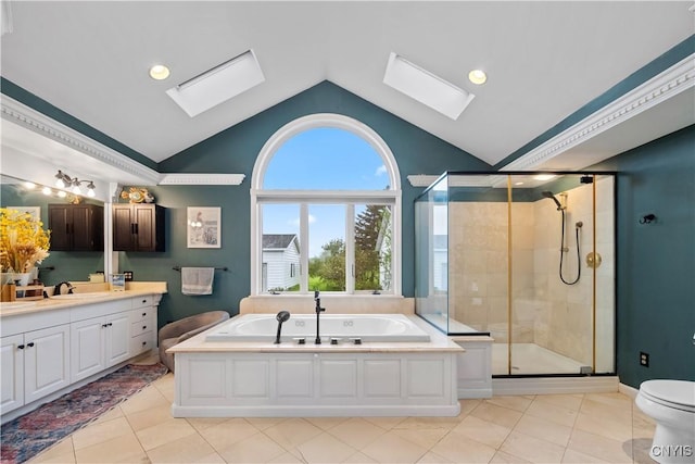 bathroom with a skylight, vaulted ceiling, tile patterned flooring, a shower stall, and recessed lighting