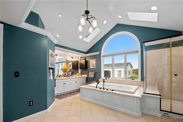 full bath featuring a skylight, a bath, vanity, tile patterned flooring, and a stall shower