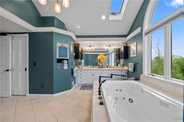 full bath with lofted ceiling, a tub with jets, tile patterned floors, a skylight, and vanity