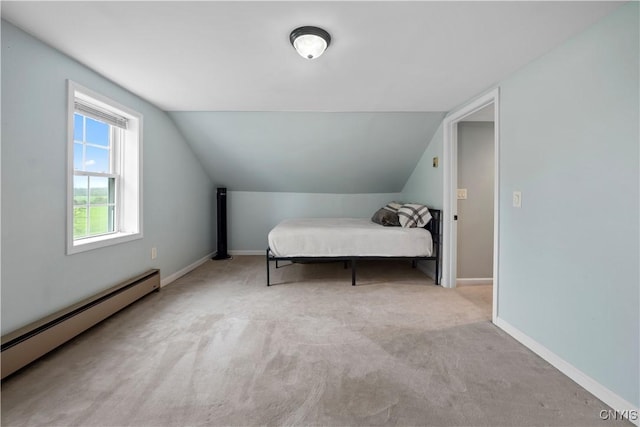 bedroom with baseboard heating, carpet, lofted ceiling, and baseboards