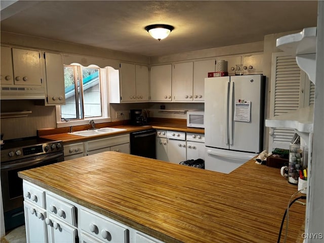 kitchen featuring white appliances, wood counters, under cabinet range hood, and a sink