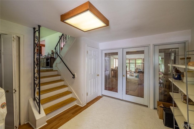 7650 Commodore Cir, Clay, NY 13090 - stairway featuring french doors and wood finished floors