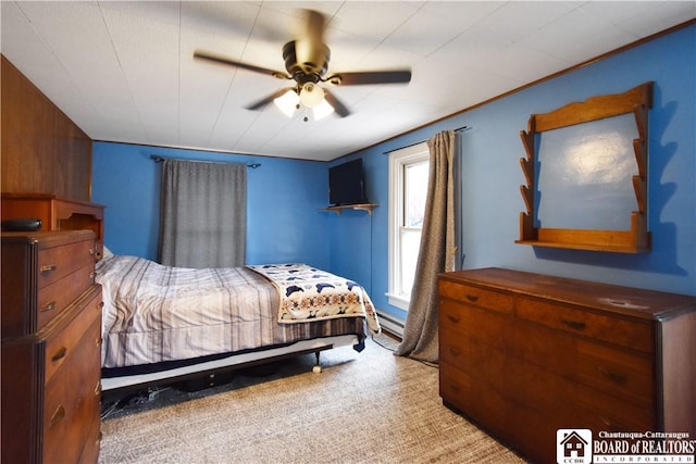 carpeted bedroom featuring baseboard heating and ceiling fan