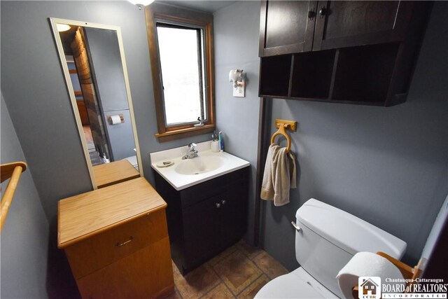 bathroom with toilet and vanity