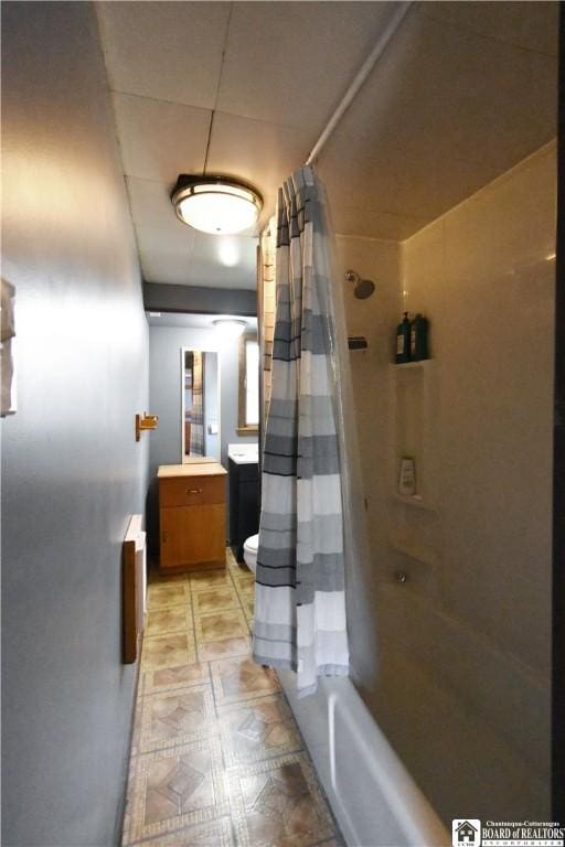 full bathroom featuring vanity, toilet, shower / bath combo with shower curtain, and tile patterned floors