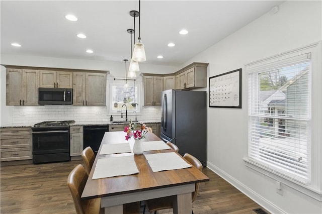 kitchen featuring black appliances, backsplash, a sink, recessed lighting, and dark wood finished floors