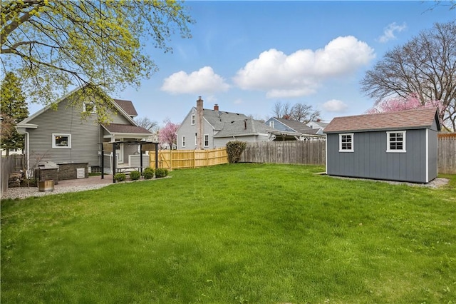 view of yard with a patio, an outbuilding, and a shed
