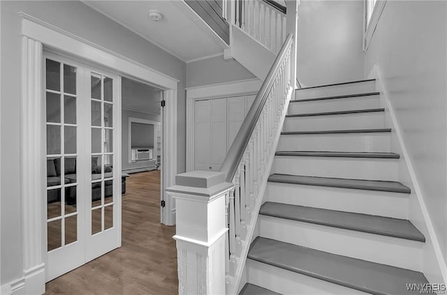 staircase with french doors and wood finished floors
