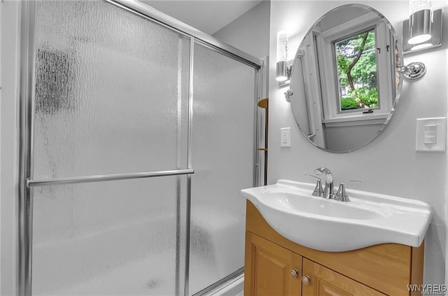bathroom with a shower stall and vanity