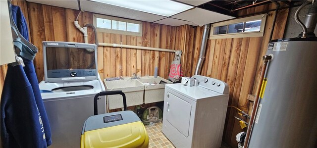 43 Sunnyside Dr, Elmira, NY 14905 - laundry room featuring wood walls, gas water heater, and separate washer and dryer