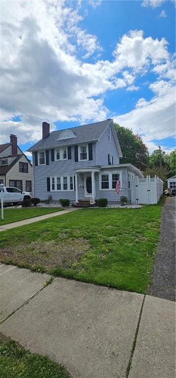 43 Sunnyside Dr, Elmira, NY 14905 - view of front of home with a front yard and a chimney