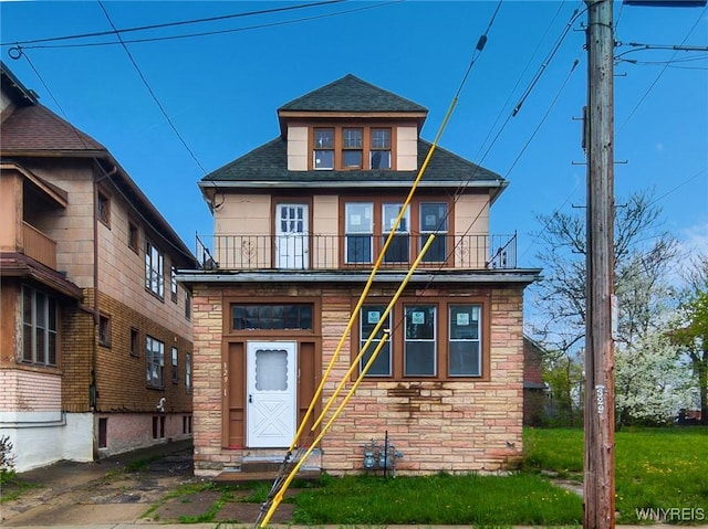 329 Jewett Ave, Buffalo, NY 14214 - view of front of home with a balcony, stone siding, a shingled roof, and entry steps