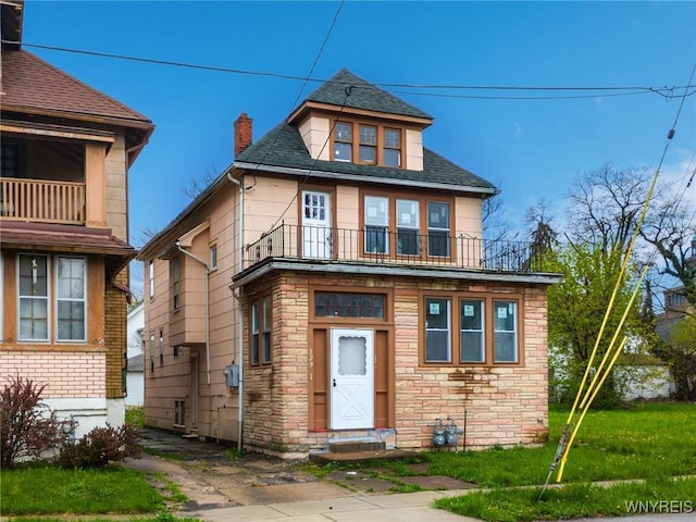 329 Jewett Ave, Buffalo, NY 14214 - view of front of house with a balcony, stone siding, a chimney, and roof with shingles