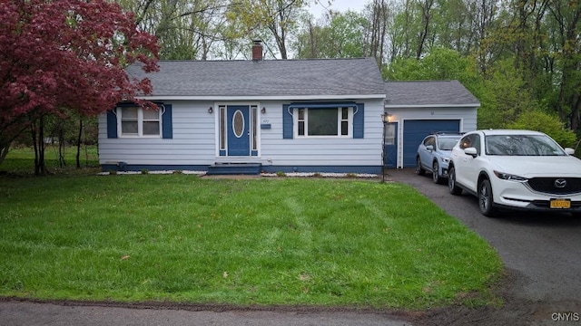 single story home featuring a garage, asphalt driveway, a front yard, a chimney, and roof with shingles