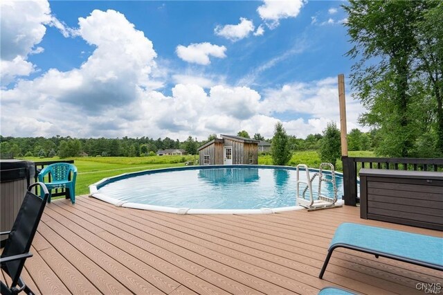 29441 Beaver Meadow Mews, Lyme, NY 13622 - outdoor pool featuring a deck, an outbuilding, and view of wooded area