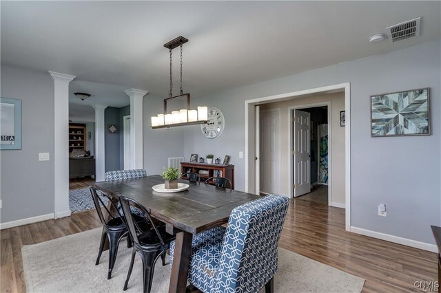 29441 Beaver Meadow Mews, Lyme, NY 13622 - dining room with ornate columns, wood finished floors, and baseboards