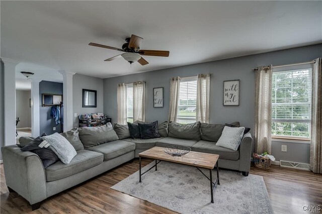 29441 Beaver Meadow Mews, Lyme, NY 13622 - living room with ornate columns, a ceiling fan, wood finished floors, and baseboards
