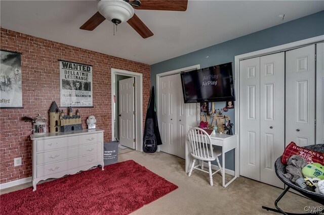 29441 Beaver Meadow Mews, Lyme, NY 13622 - bedroom with two closets, brick wall, carpet, and a ceiling fan