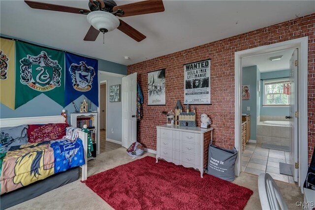 29441 Beaver Meadow Mews, Lyme, NY 13622 - bedroom with carpet flooring, brick wall, ceiling fan, and connected bathroom