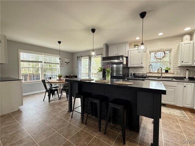 29441 Beaver Meadow Mews, Lyme, NY 13622 - kitchen with freestanding refrigerator, a sink, dark countertops, healthy amount of natural light, and recessed lighting