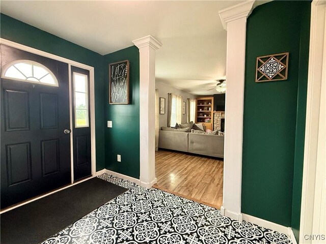 29441 Beaver Meadow Mews, Lyme, NY 13622 - tiled entryway with healthy amount of natural light, ornate columns, a ceiling fan, and baseboards