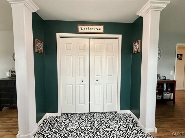 29441 Beaver Meadow Mews, Lyme, NY 13622 - bedroom featuring ornate columns, baseboards, a closet, and wood finished floors