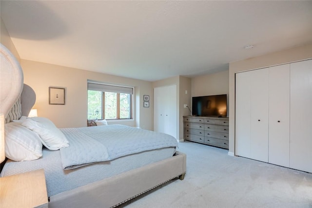 bedroom with light colored carpet and a closet