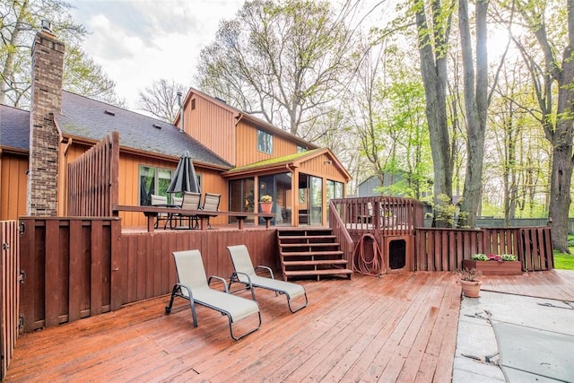 wooden deck featuring a sunroom